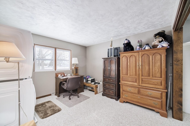 office with washing machine and dryer, light colored carpet, a textured ceiling, and baseboards