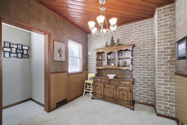 dining room featuring visible vents, wooden ceiling, light carpet, and a wainscoted wall