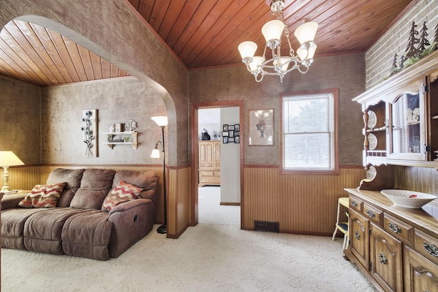 living room with light carpet, wooden ceiling, and wainscoting