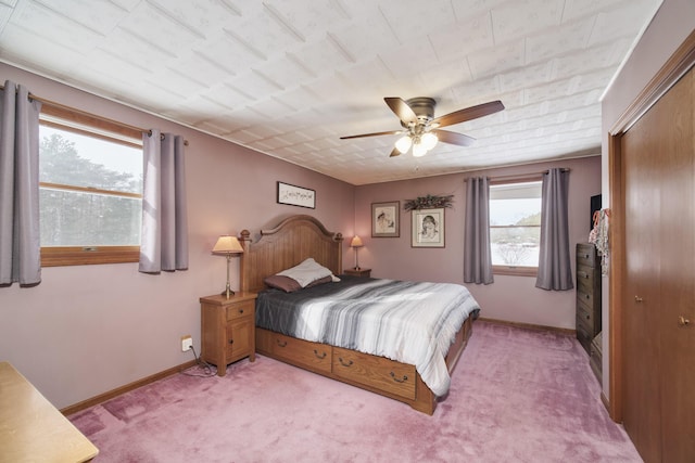 bedroom with light carpet, a ceiling fan, and baseboards