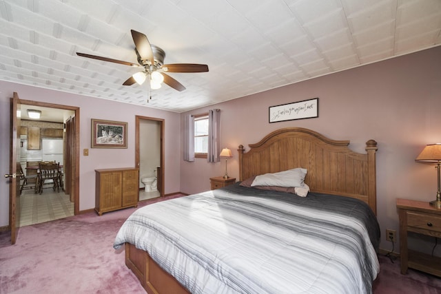 carpeted bedroom featuring freestanding refrigerator and a ceiling fan