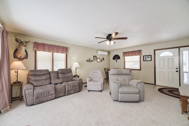 carpeted living room featuring a wall mounted air conditioner and a ceiling fan