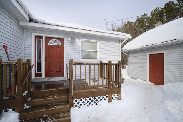 view of snow covered property entrance