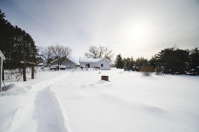 yard covered in snow with a garage