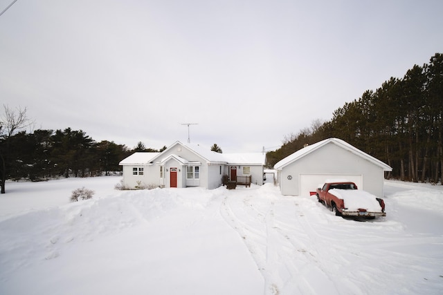 view of front of house featuring an outdoor structure and a detached garage