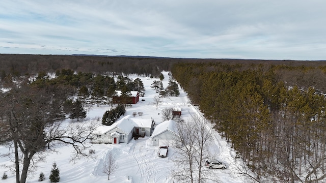 snowy aerial view featuring a view of trees