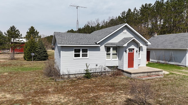 bungalow-style home featuring roof with shingles