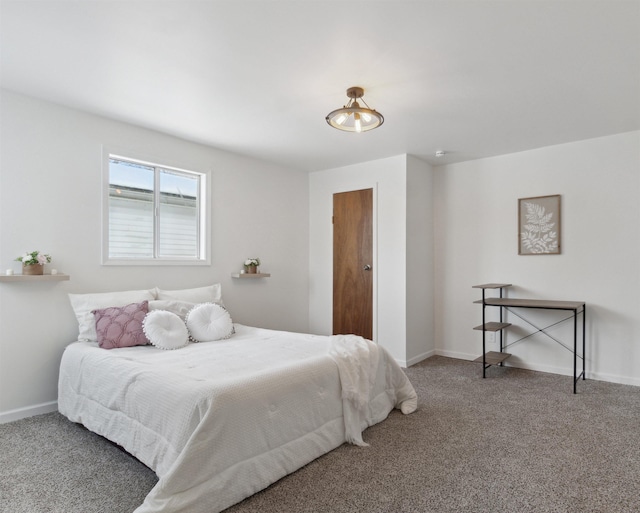 carpeted bedroom featuring baseboards