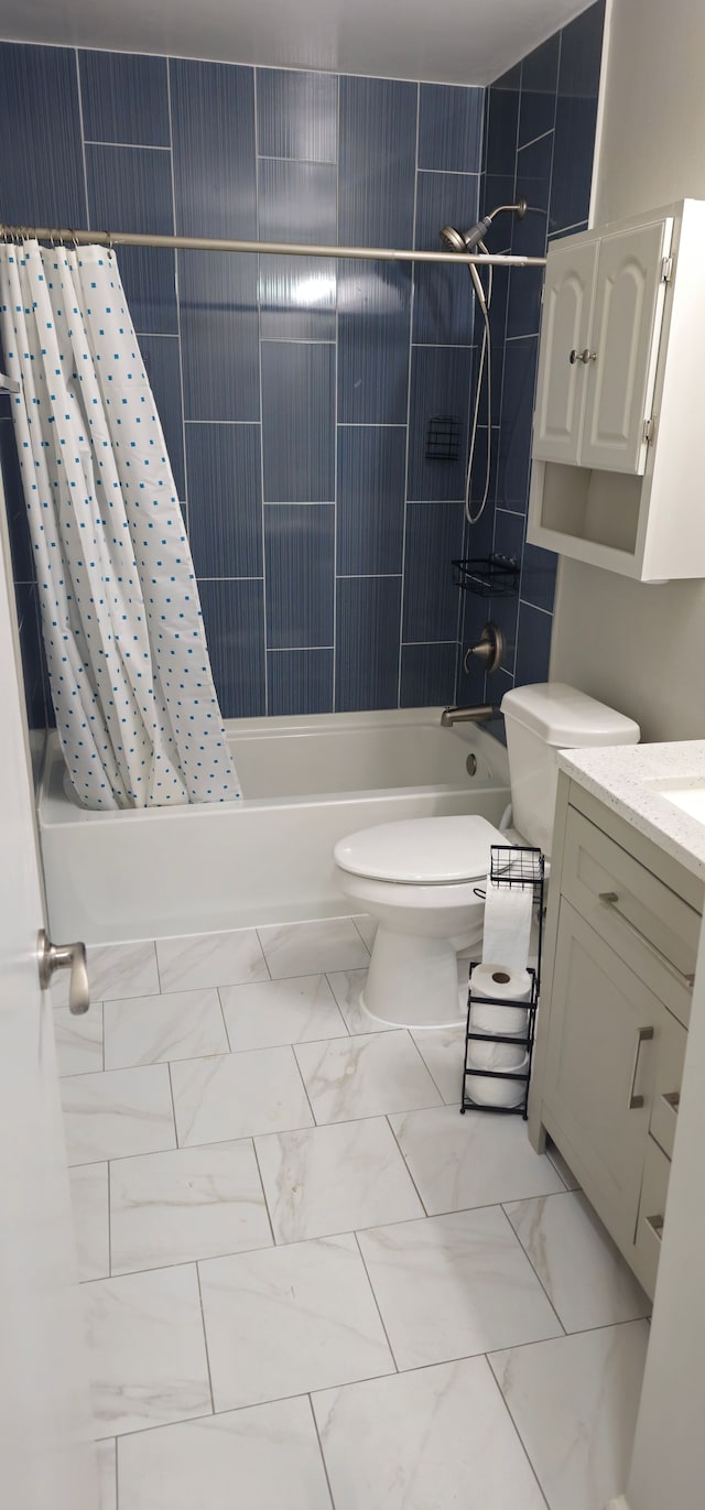 full bathroom featuring toilet, marble finish floor, shower / bath combo with shower curtain, and vanity