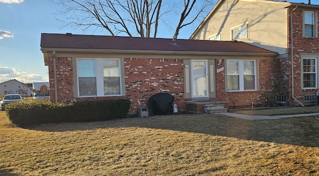 view of front of home with a front yard and brick siding