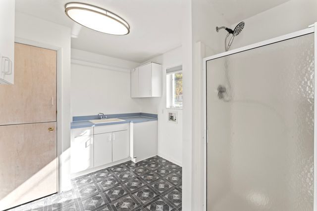 bathroom featuring a shower stall, vanity, and tile patterned floors