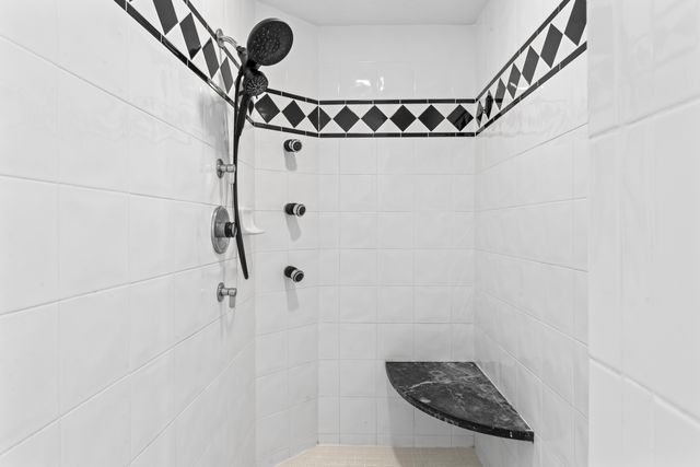 bathroom with a tile shower