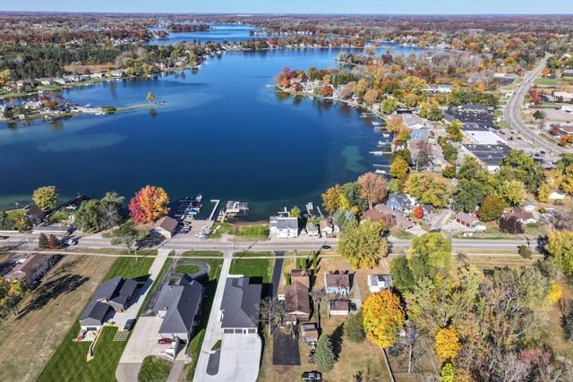 drone / aerial view featuring a water view and a residential view