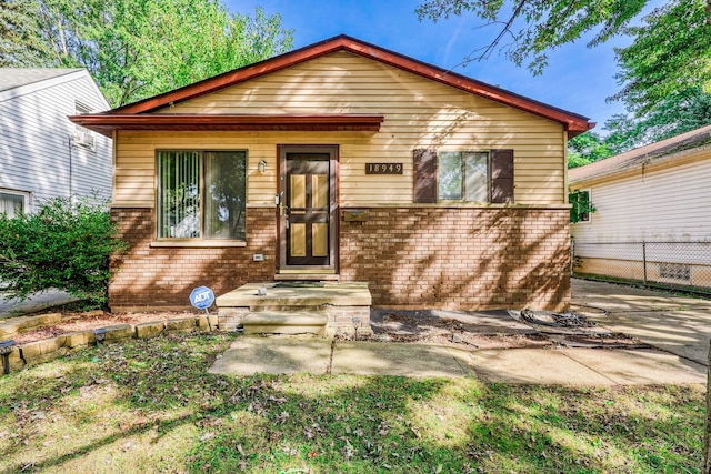 view of front of home with fence and brick siding