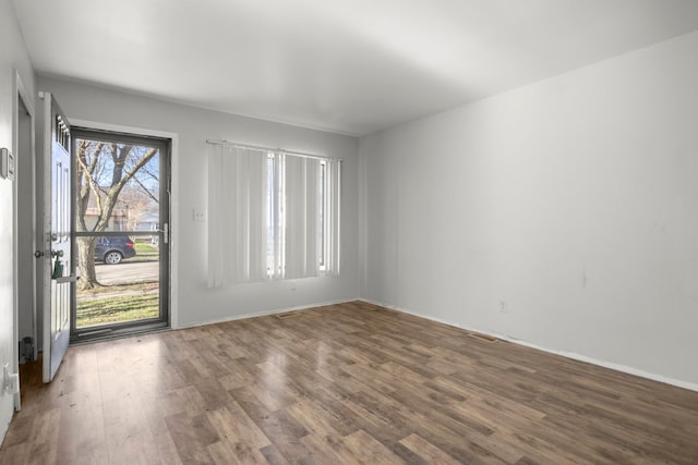 spare room with wood finished floors