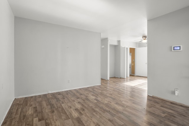 spare room featuring ceiling fan and wood finished floors