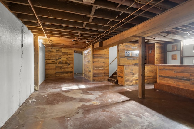 unfinished basement featuring stairway