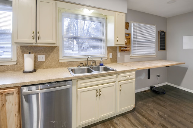 kitchen with a sink, light countertops, stainless steel dishwasher, backsplash, and dark wood-style floors