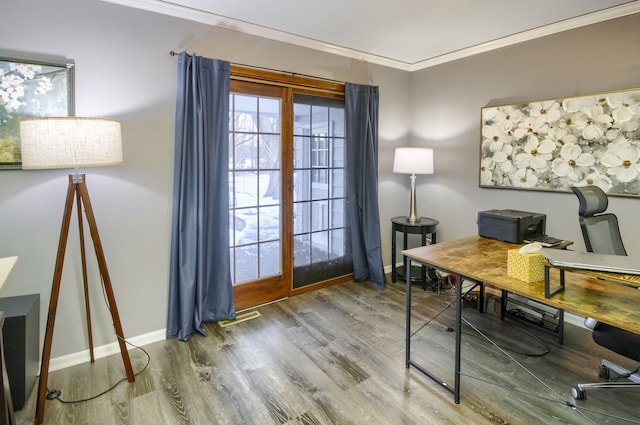 home office featuring baseboards, visible vents, ornamental molding, and wood finished floors