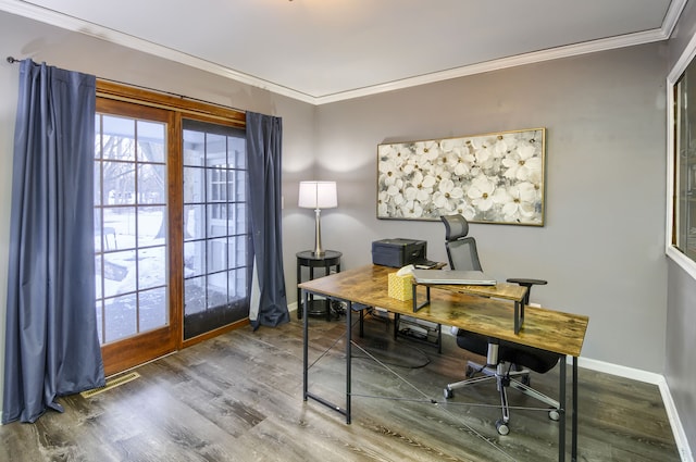 office space featuring baseboards, wood finished floors, visible vents, and crown molding