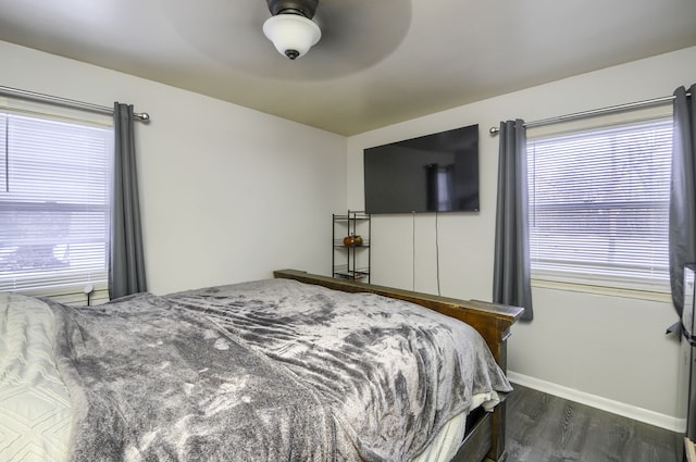 bedroom featuring dark wood-style floors, ceiling fan, and baseboards