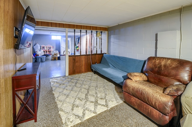 living room featuring concrete block wall