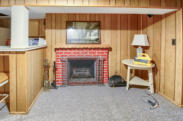 living area featuring a fireplace, carpet flooring, and wooden walls