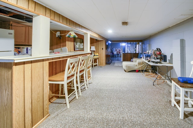 living area featuring carpet floors and concrete block wall