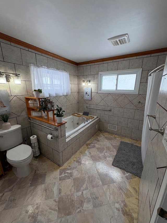 bathroom featuring visible vents, toilet, tile walls, and a whirlpool tub