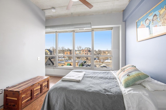 bedroom featuring a ceiling fan and wood finished floors