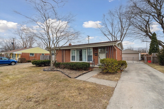 view of front of home with brick siding, an outdoor structure, a front lawn, and fence