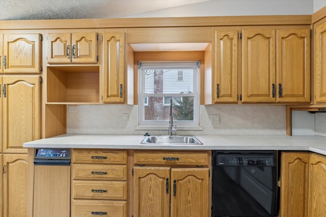 kitchen with a sink, black dishwasher, and light countertops