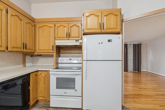 kitchen featuring white appliances, light wood-style flooring, light countertops, under cabinet range hood, and brown cabinets