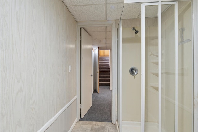 full bathroom with a drop ceiling and a stall shower