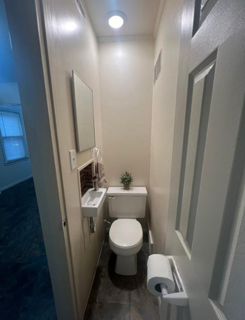 bathroom featuring visible vents and toilet