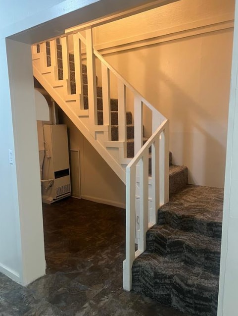 staircase featuring stone finish flooring