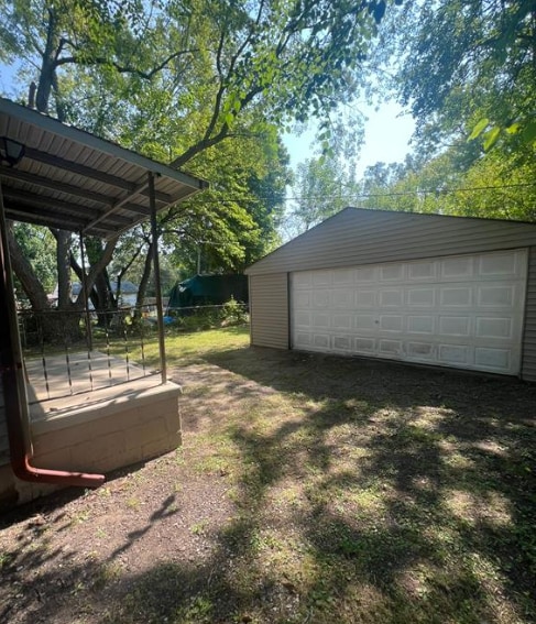 view of yard with a garage, an outdoor structure, and fence