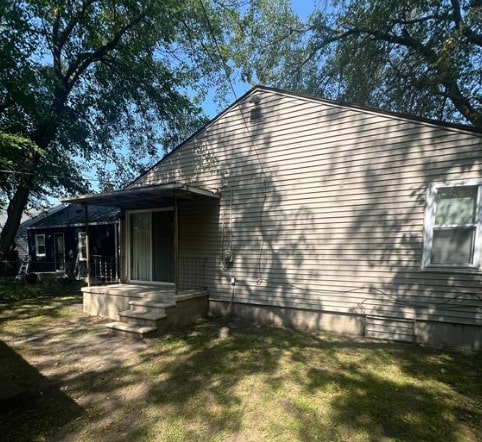 view of side of home featuring a yard