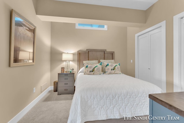 bedroom featuring light carpet and baseboards