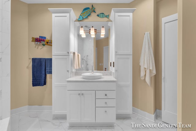 bathroom featuring marble finish floor, vanity, and baseboards