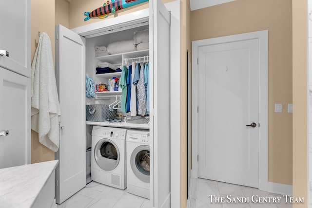 laundry room featuring marble finish floor, washing machine and dryer, and laundry area