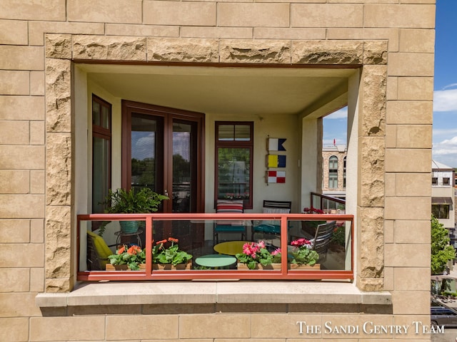 view of exterior entry featuring stone siding