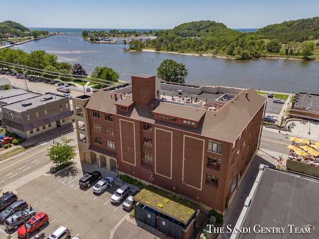 birds eye view of property with a water view