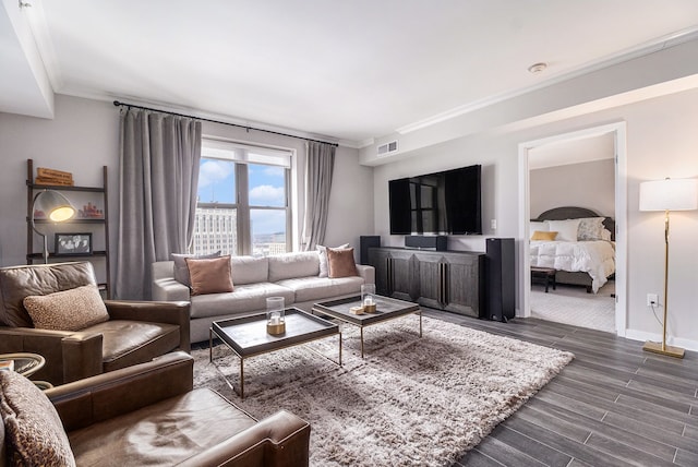 living room featuring visible vents, ornamental molding, baseboards, and wood tiled floor