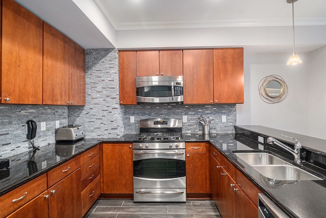 kitchen with dark stone countertops, ornamental molding, a sink, appliances with stainless steel finishes, and tasteful backsplash