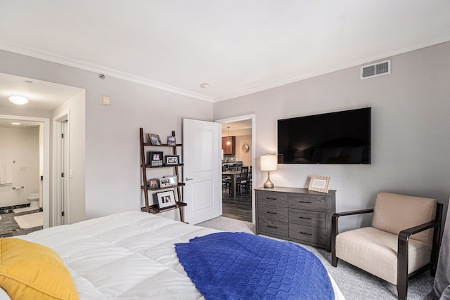 bedroom featuring visible vents, ensuite bath, and crown molding