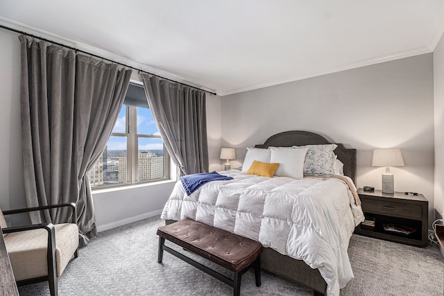 carpeted bedroom featuring crown molding and baseboards