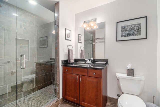 bathroom with vanity, toilet, and a shower stall