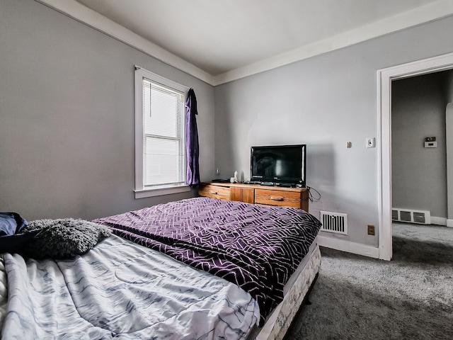 bedroom featuring crown molding, carpet flooring, visible vents, and baseboards