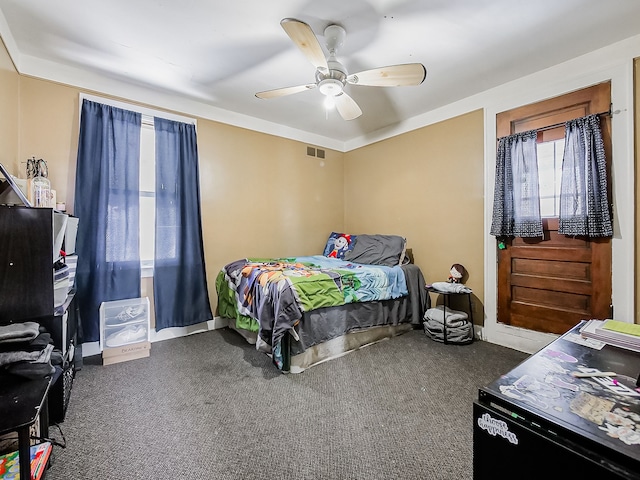 bedroom featuring baseboards, ceiling fan, visible vents, and carpet flooring